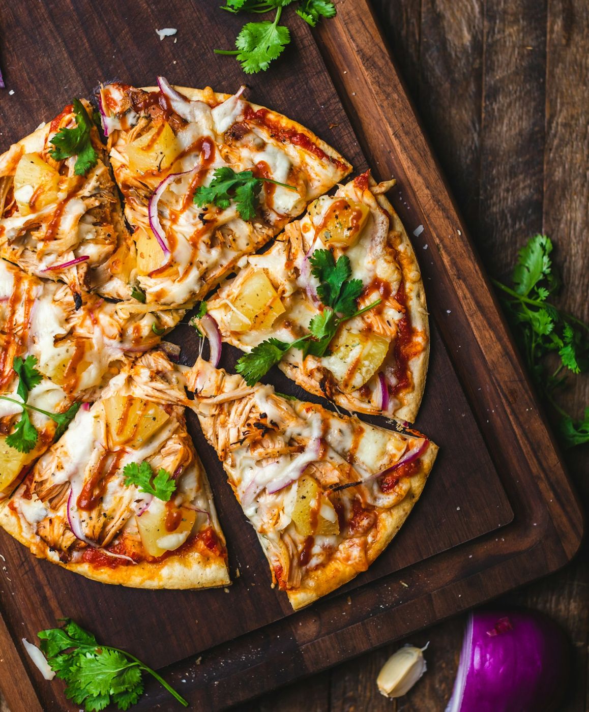 Pizza speciale tagliata a spicchi su tagliere